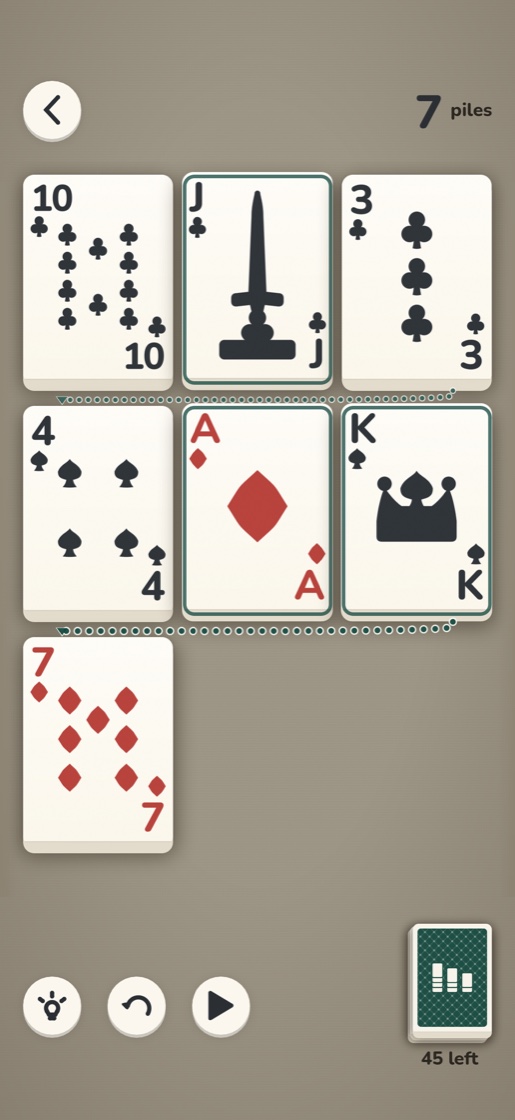 A hand of Dwindle in play: cards laid out in a wrapping line on a warm linen table, with three cards outlined as playable.